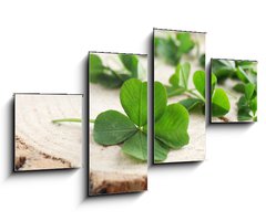 Obraz 4D tydln - 100 x 60 cm F_IS110661857 - Green clover leaves on a piece of wood, closeup