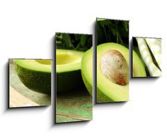 Obraz   ripe avocado cut in half on a wooden table, 100 x 60 cm